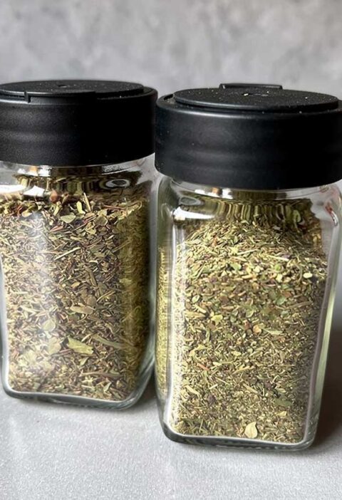 2 kruidenpotjes met gedroogde, klein gemaakte, basilicum.