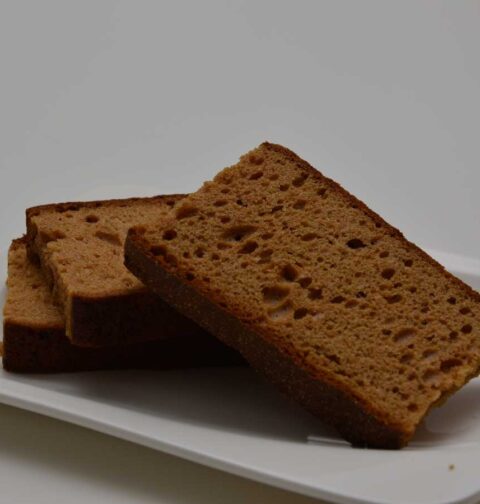 3 plakken ontbijtkoek liggen op een wit schaaltje, klaar om in te vriezen.