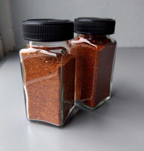 Twee kruidenpotjes met een chili con carne kruidenmix.