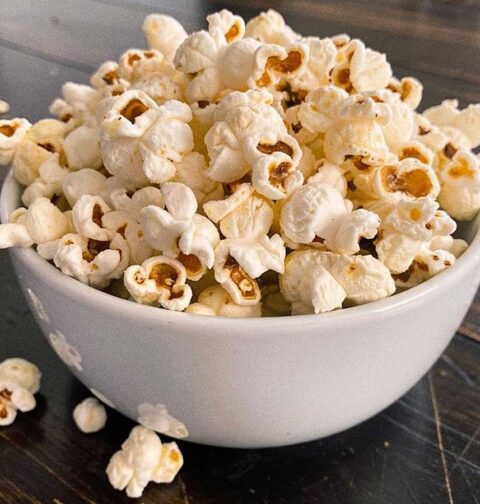 Een wit schaaltje gevuld met net gemaakte popcorn.