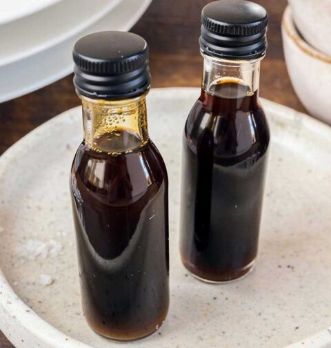 Twee kleine flesjes met daarin zelfgemaakte balsamico vinaigrette.