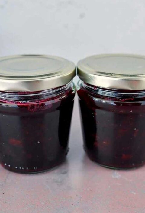 Twee jampotten met daarin blauwe honingbes jam.